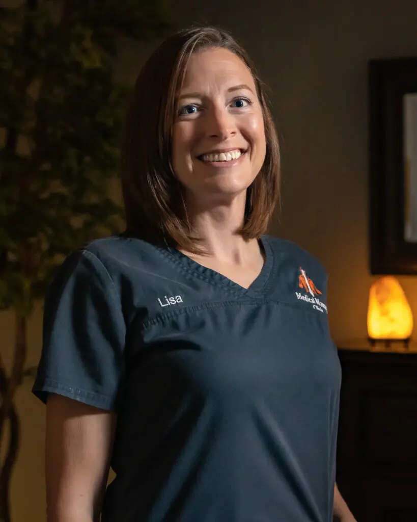 A woman standing in front of a lamp.