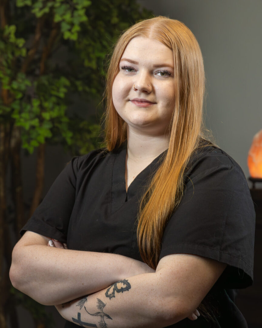 Redhead woman with arms crossed.